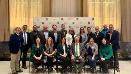 4-H Canada Board of Director members posed in front of 4-H Canada backdrop